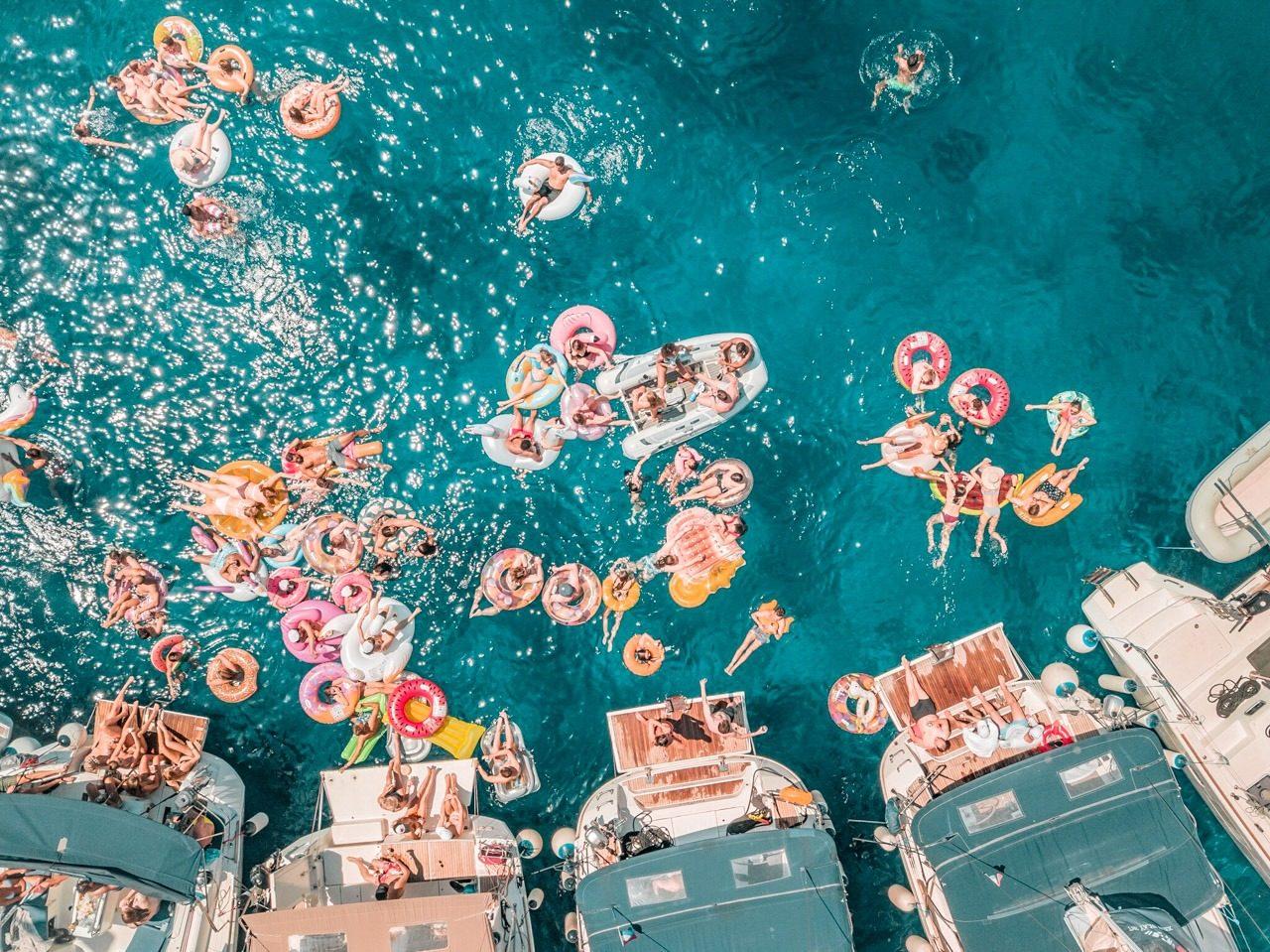 Yacht Week'er swimming at a circle raft